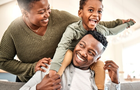 A smiling family playing together at home